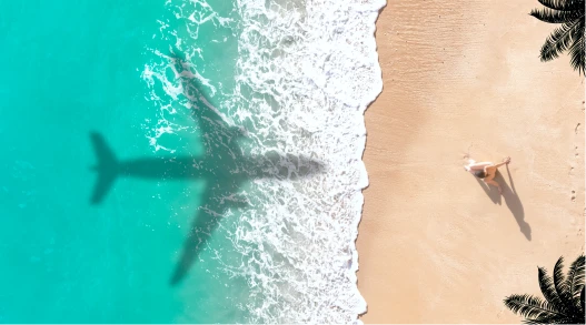 A plane flying over a beach